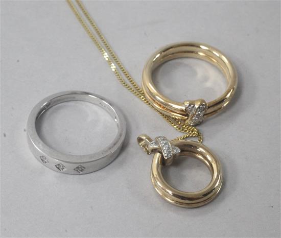 A 9ct gold and diamond double kiss ring, a matching pendant on chain and a 9ct white gold and diamond gypsy-set ring.